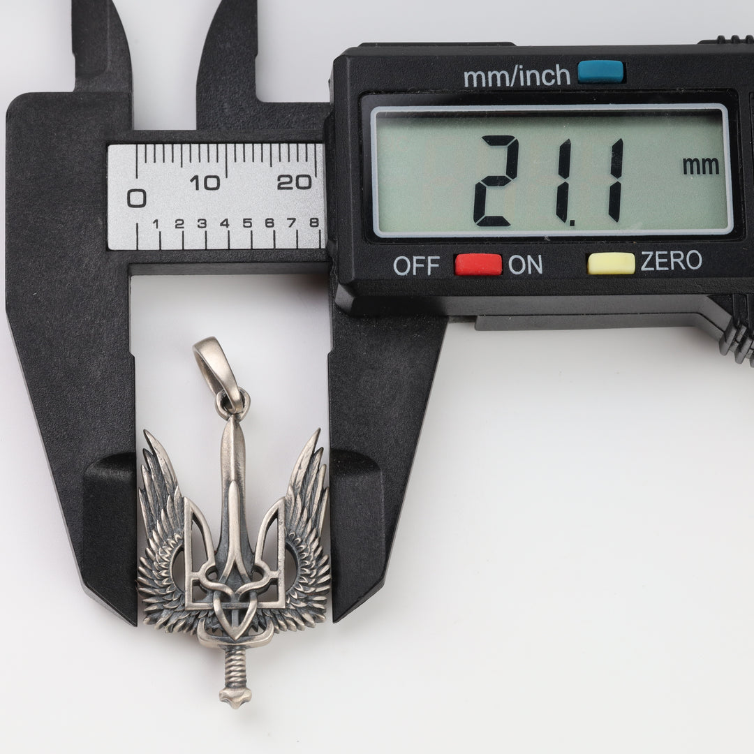Winged trident pendant width measured with a caliper at 21.1 mm