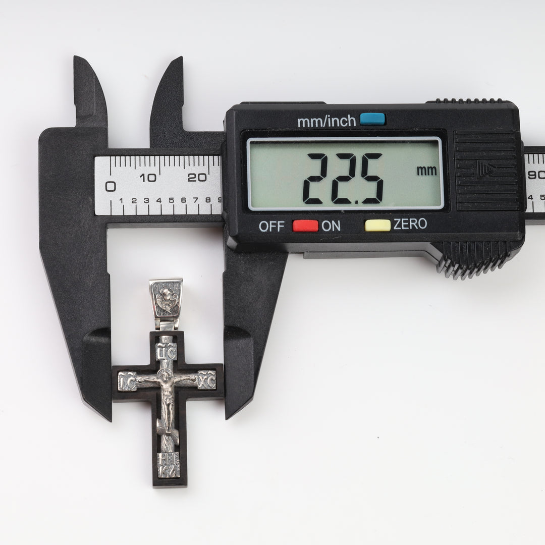 Ebony cross pendant width measured with a caliper at 22.5 mm
