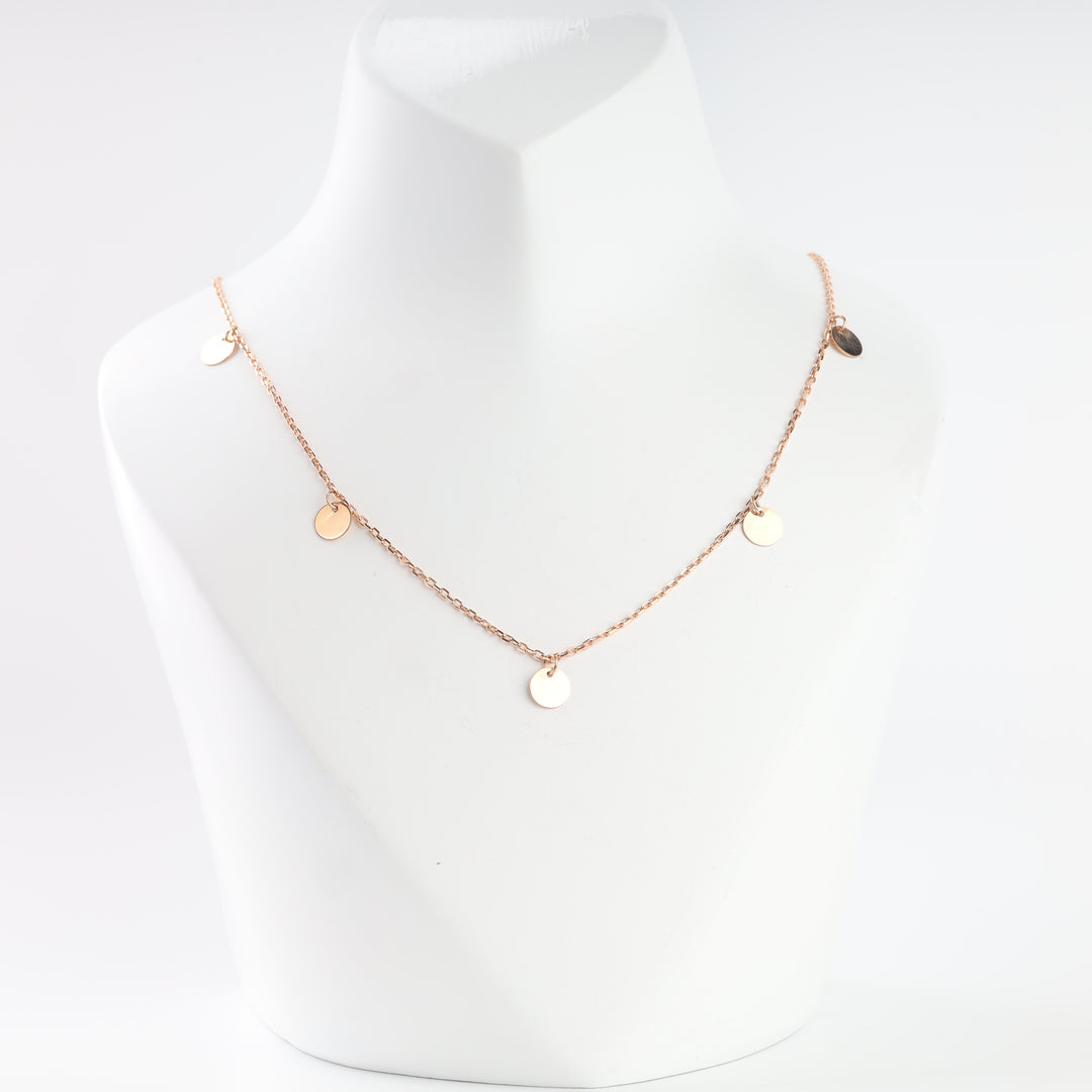 14K rose gold disc drop necklace on a display bust