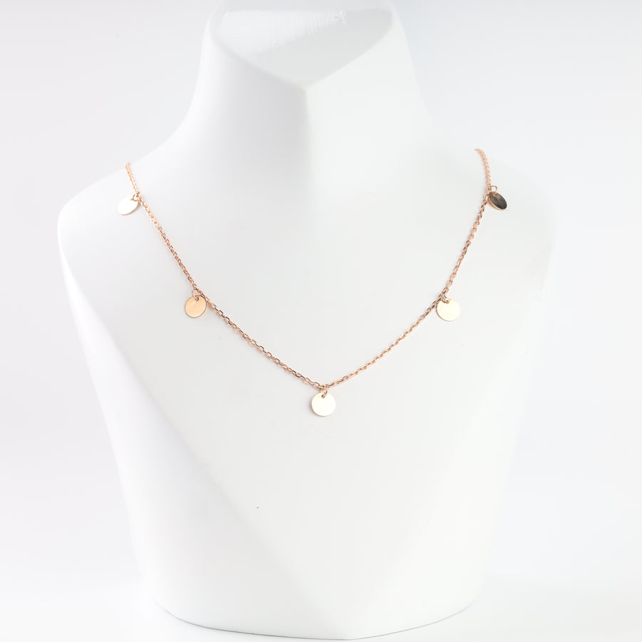14K rose gold disc drop necklace on a display bust