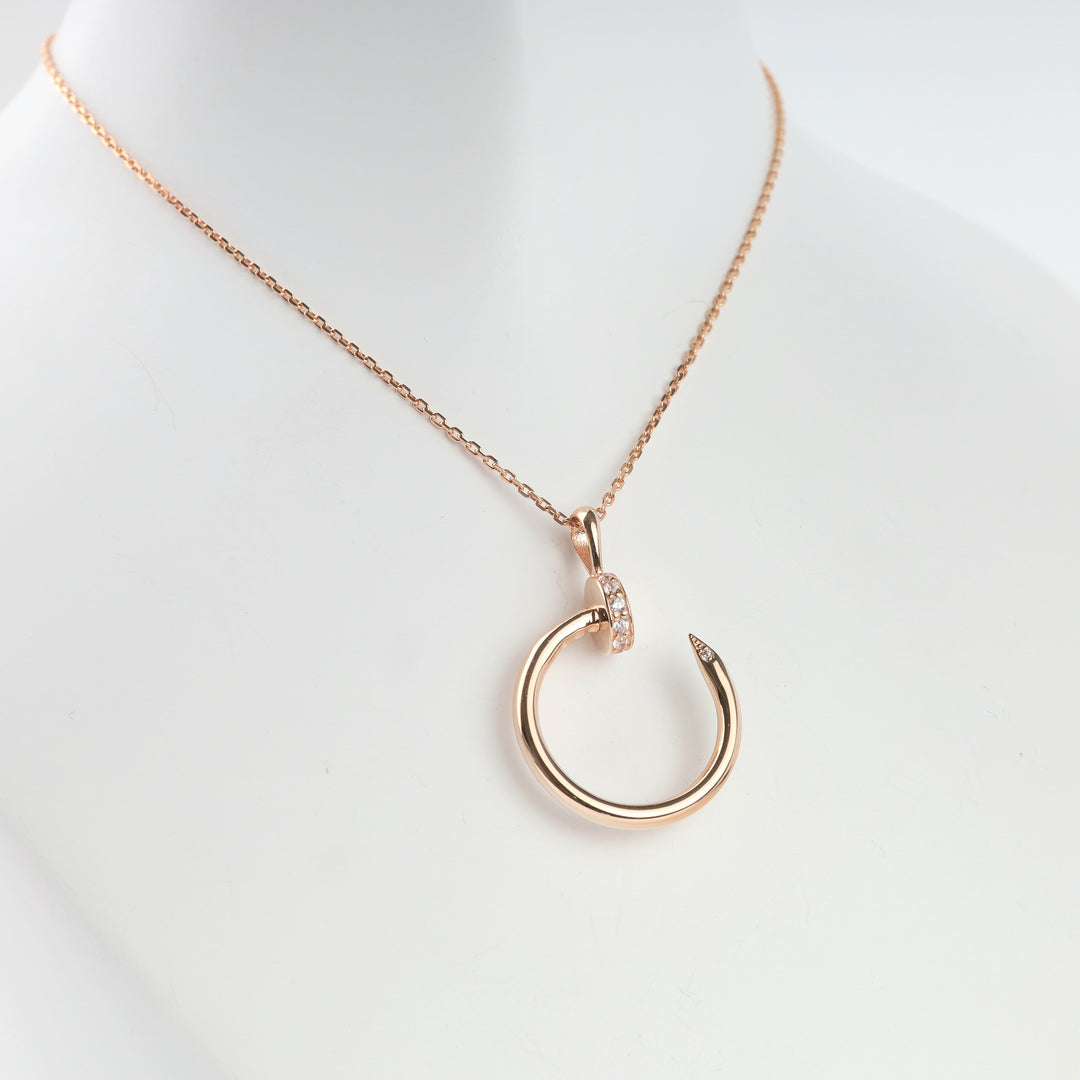 Rose gold nail circle pendant, detail of cubic zirconia head