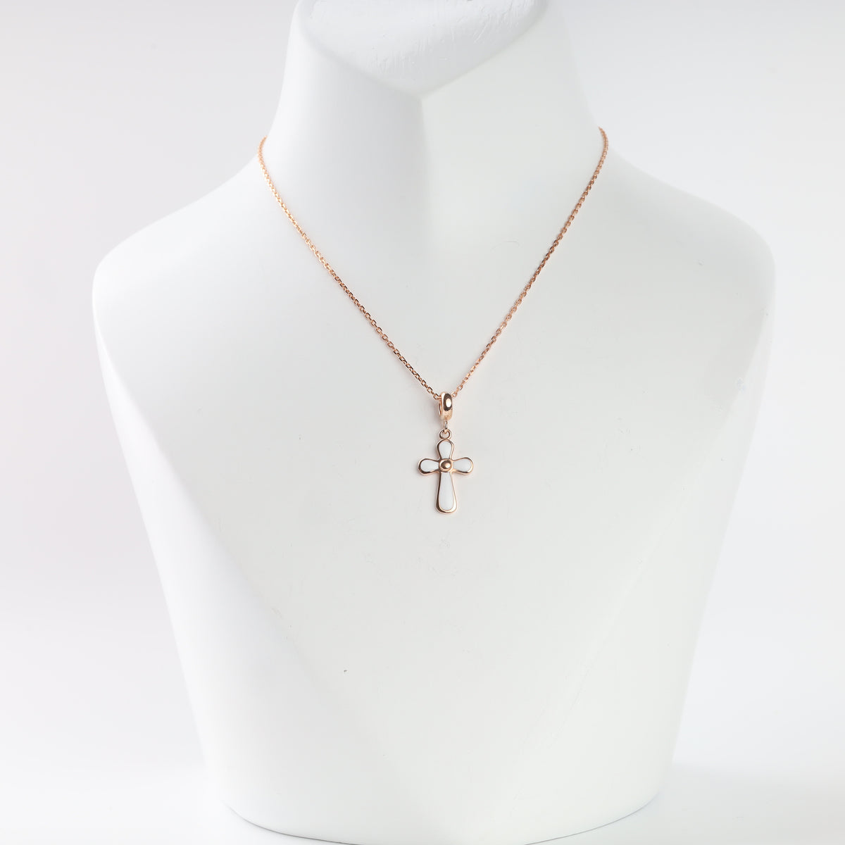 14K rose gold cross pendant with white enamel on a chain