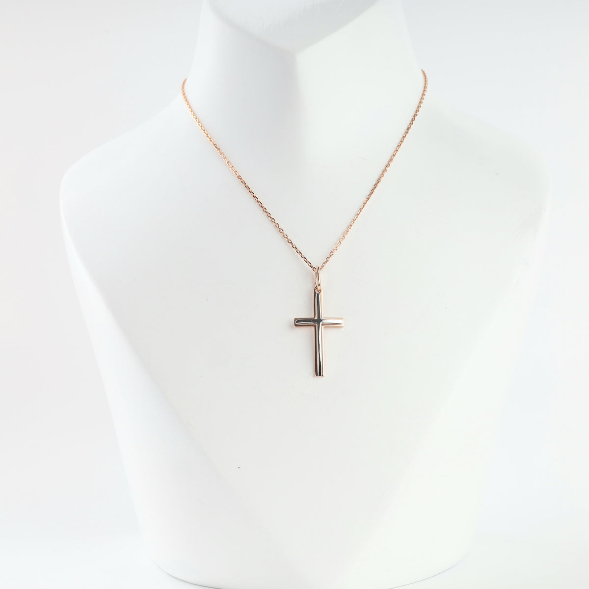 14K two-tone gold cross pendant on a rose gold chain