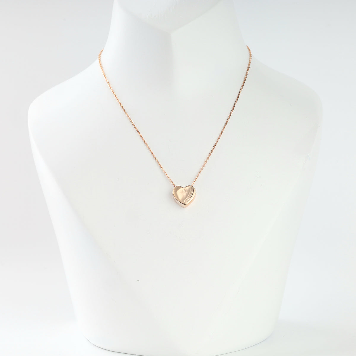 14K rose gold puffed heart pendant on a thin chain