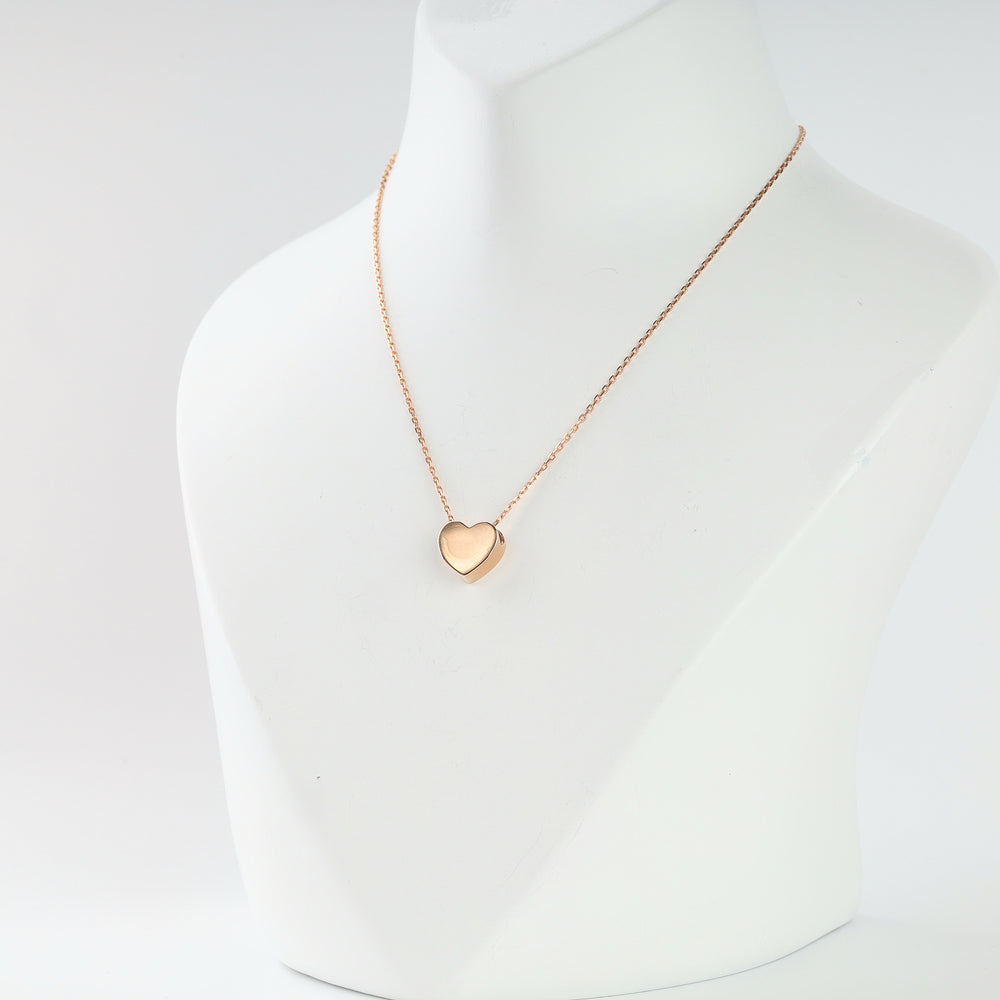 Rose gold domed heart pendant close-up