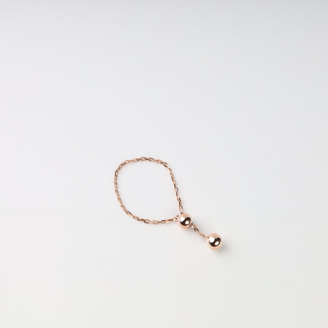 Fine rose gold chain ring with sliding bead and ball drop