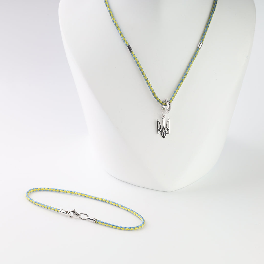 Sterling silver lobster clasp and blue-yellow braided cord detail