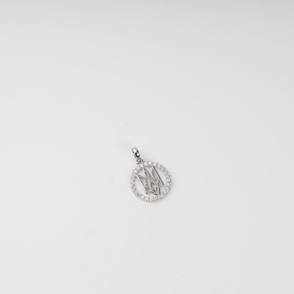 Round sterling silver 925 Tryzub pendant with a border of clear stones