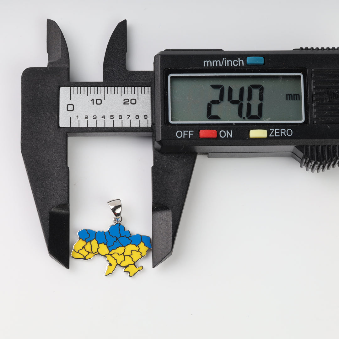 Horizontal caliper measuring the blue and yellow Ukraine map pendant width at 24.0 mm