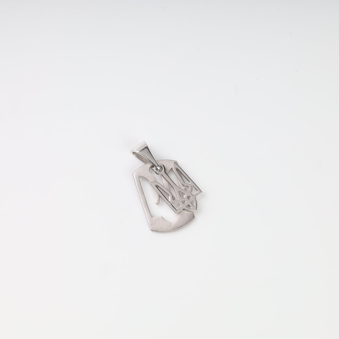 Angled view showing the openwork construction and satin surface of the silver Tryzub tag pendant