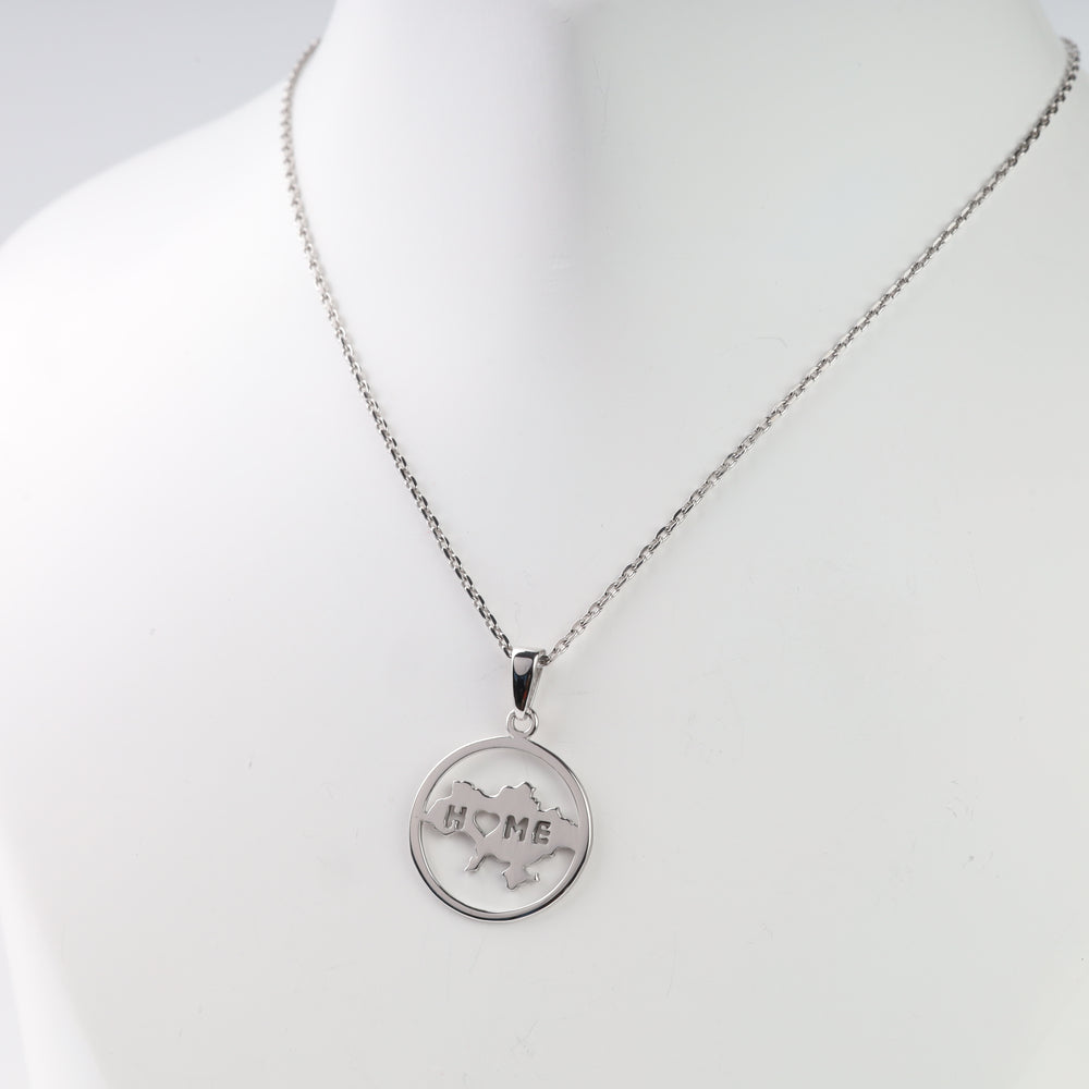 Close view of the round Ukraine map pendant with HOME lettering and a heart-shaped letter O