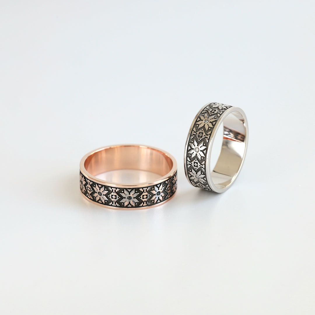White and rose gold Ukrainian vyshyvanka wedding bands side by side