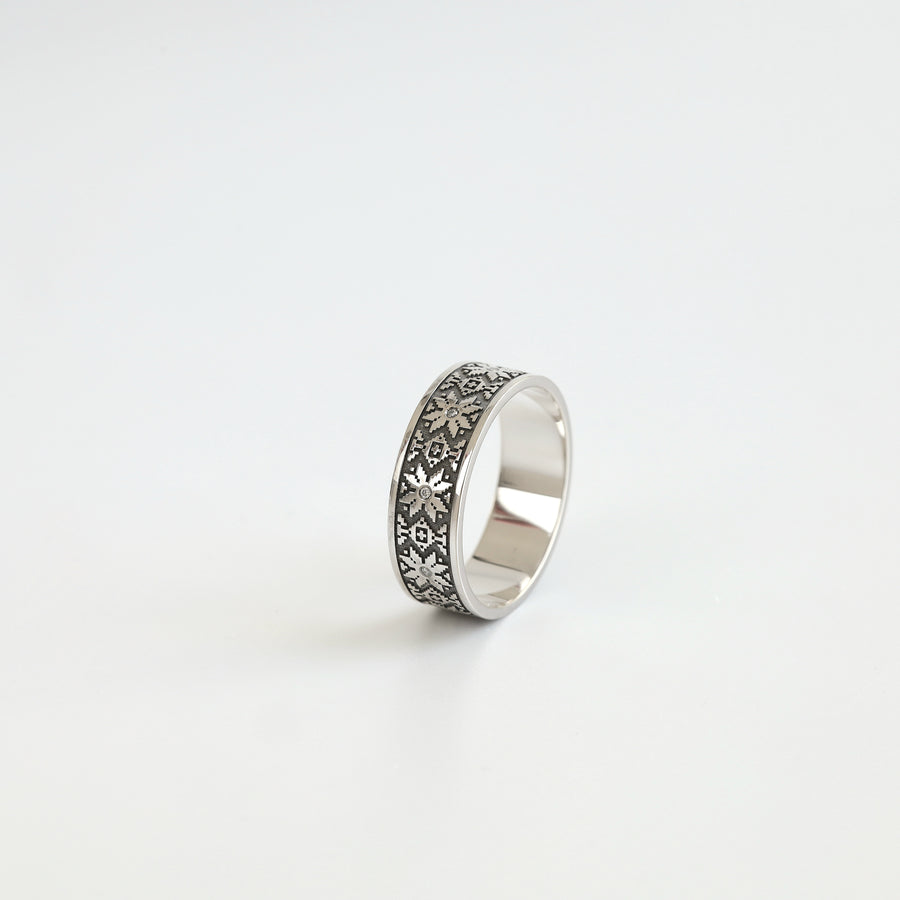Ukrainian vyshyvanka wedding band in 14K white gold with white diamond accents, angled view