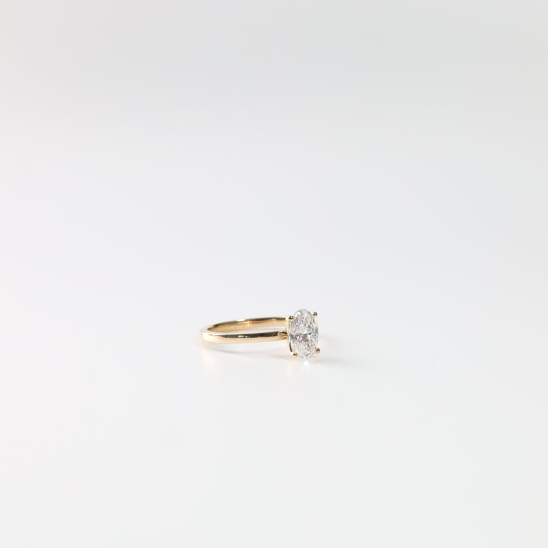 18K yellow gold oval lab-grown diamond solitaire ring, front view on a white background.