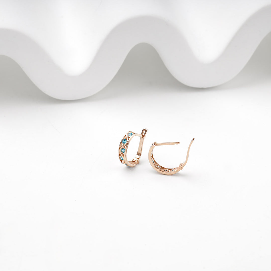 Side view of 14K rose gold hoop earrings with the English lock clasp