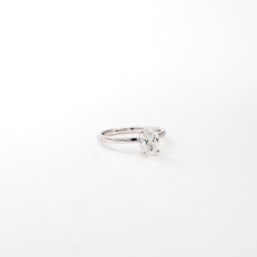 Oval lab-grown diamond solitaire ring in 14K white gold, three-quarter view on a white background.