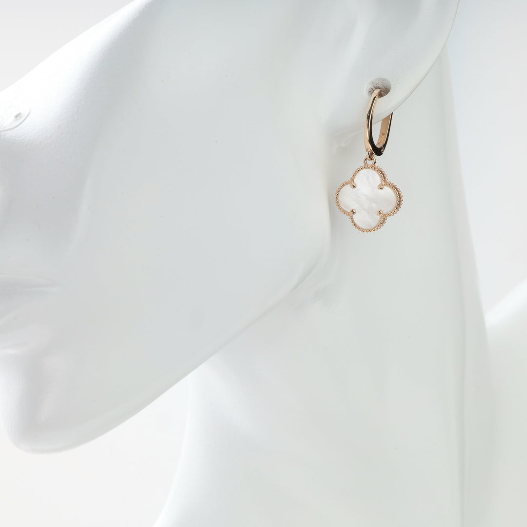 Mother-of-pearl clover drop earring in 14K rose gold on a display