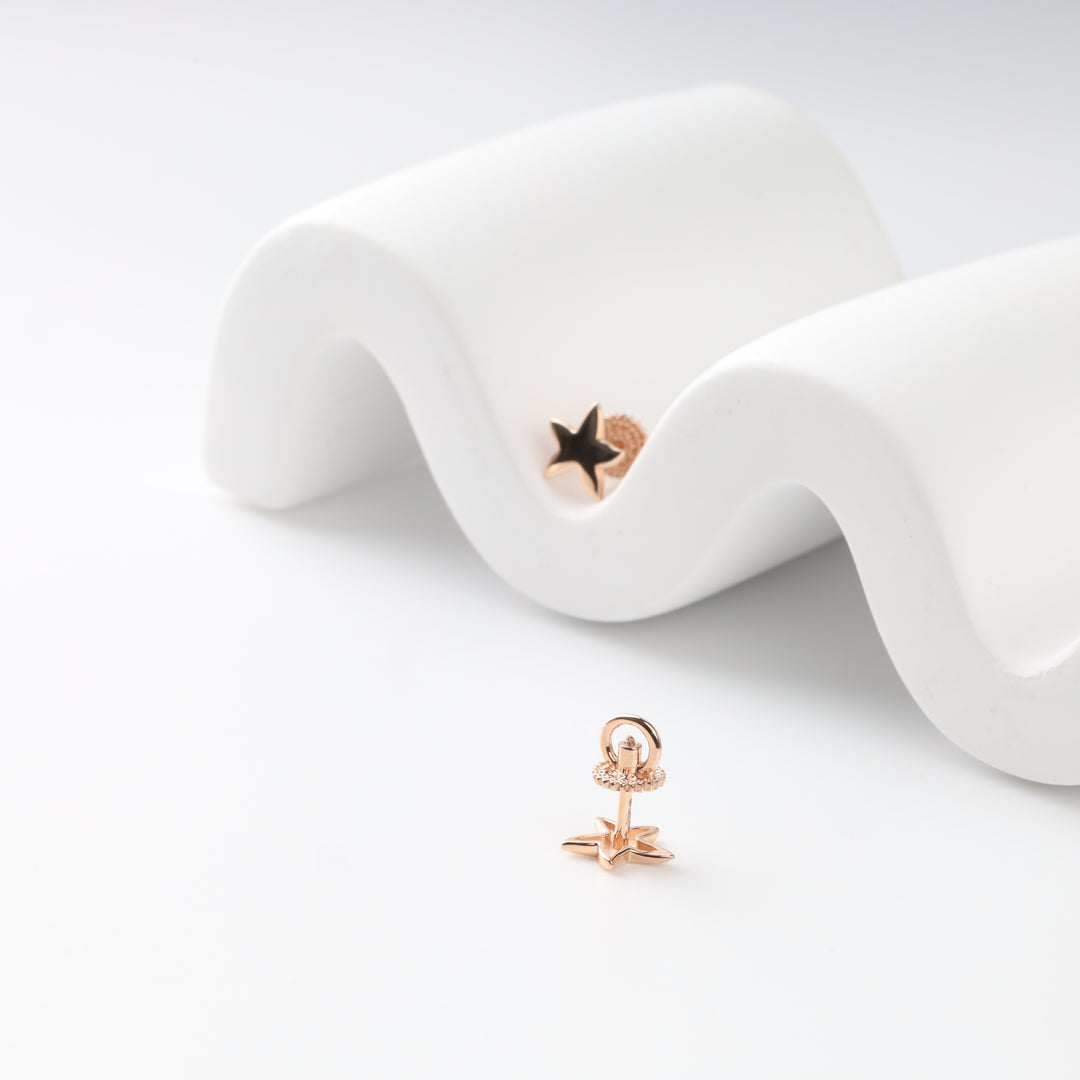 Front and back view of rose gold star earrings with screw backs