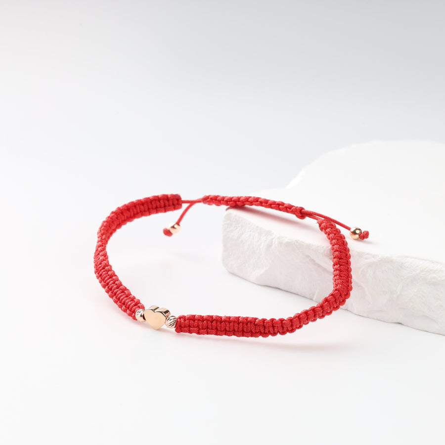 Adjustable red cord heart bracelet in 14K rose gold, front view