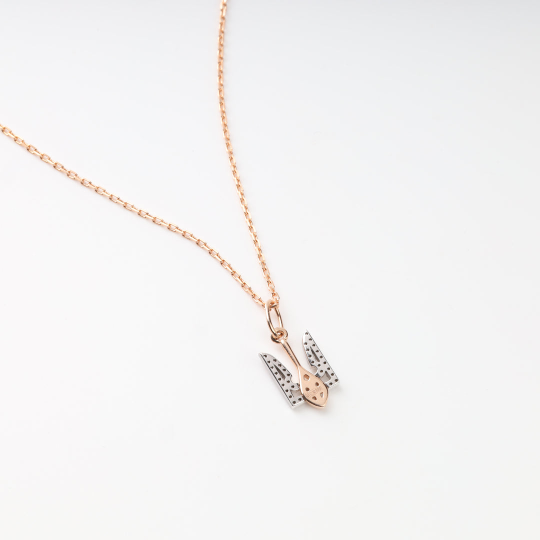 Reverse of two-tone 585 gold Tryzub pendant showing open stone settings