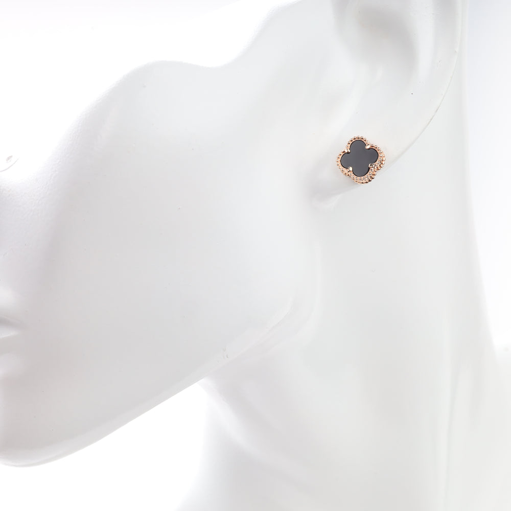 Black onyx rose gold clover stud earring shown on an ear