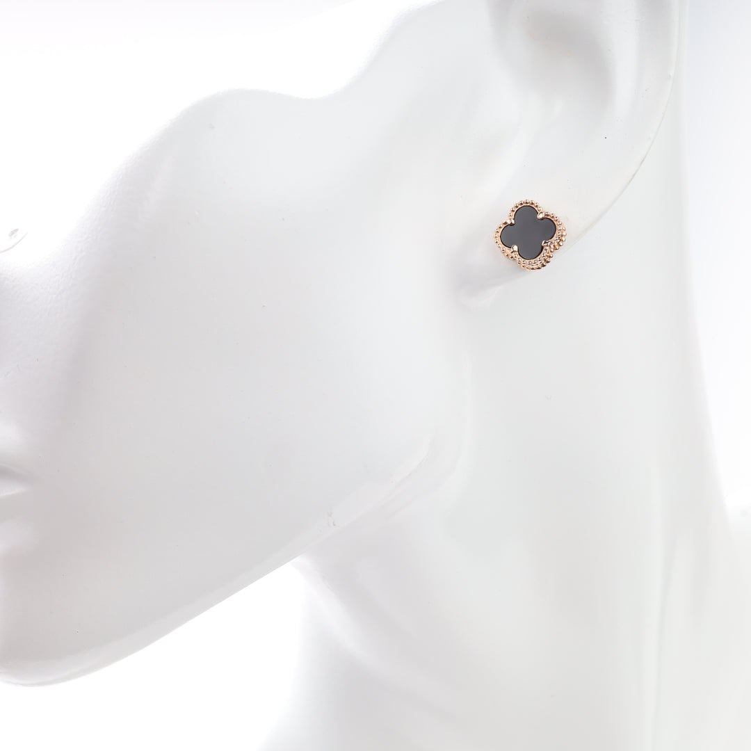 Black onyx rose gold clover stud earring shown on an ear