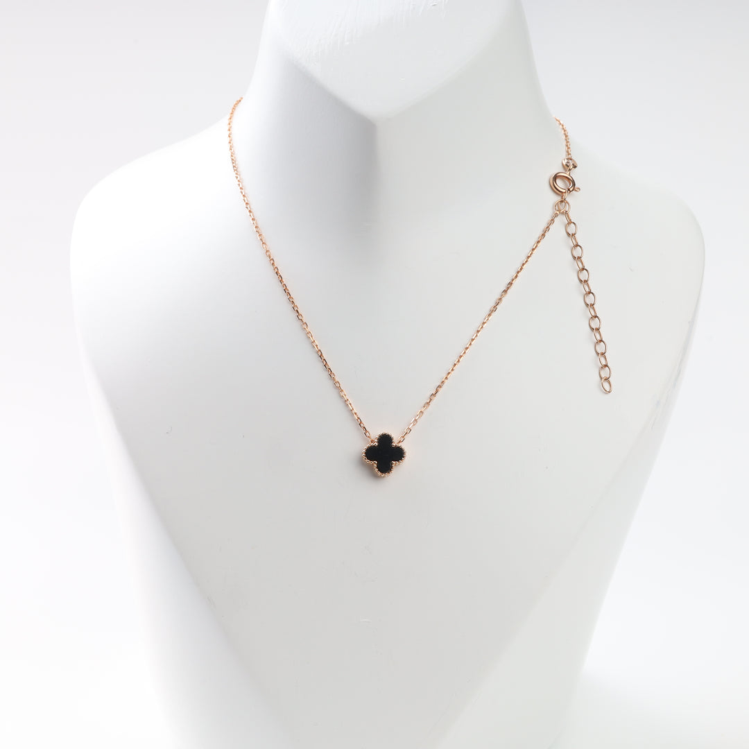 Black clover necklace in 14K rose gold on display bust