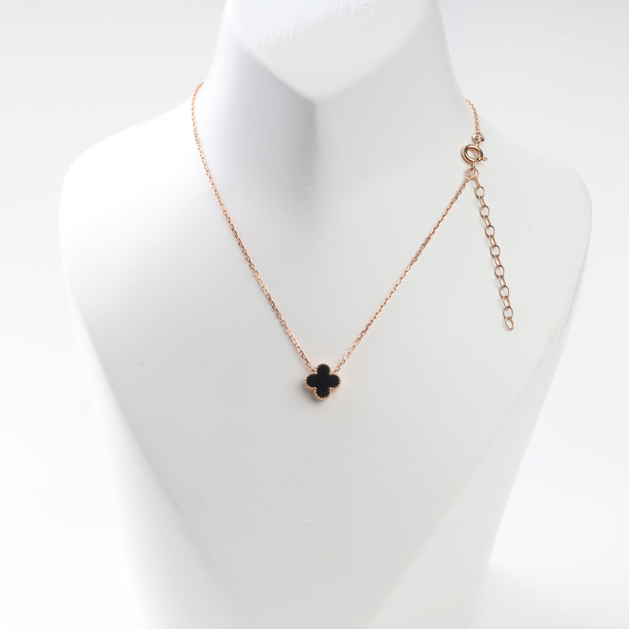 Black clover necklace in 14K rose gold on display bust