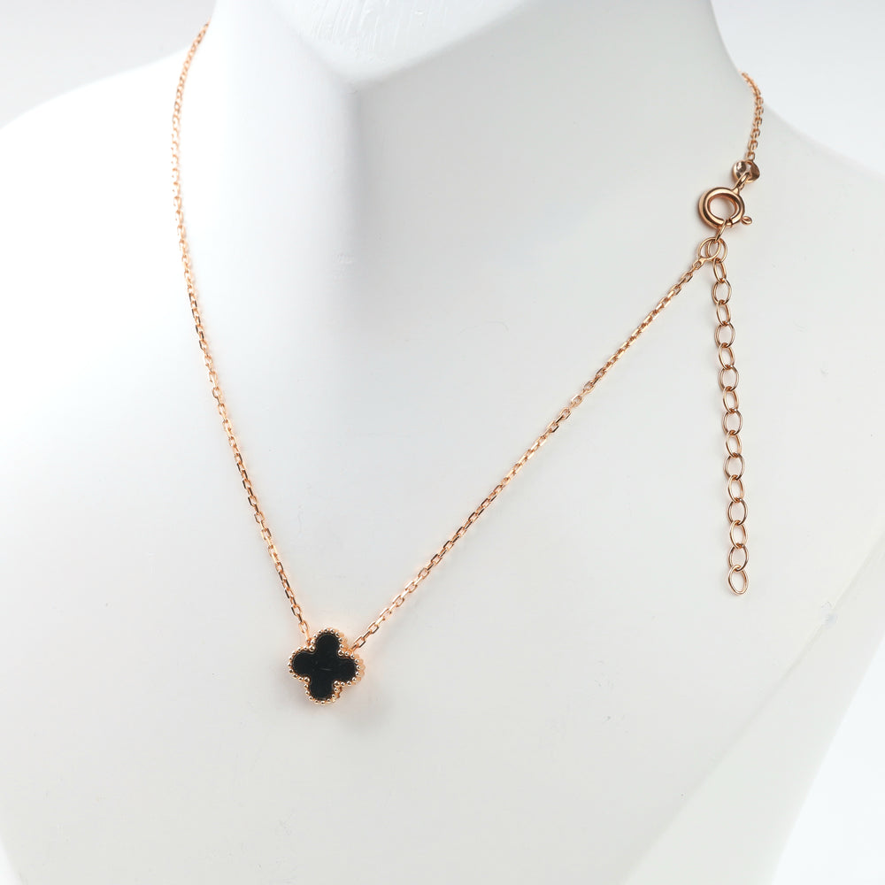 Close front view of black four-leaf clover necklace