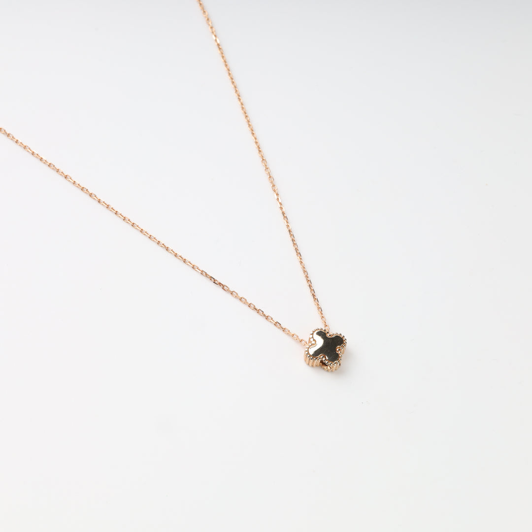 Back view of black clover centerpiece on rose gold necklace