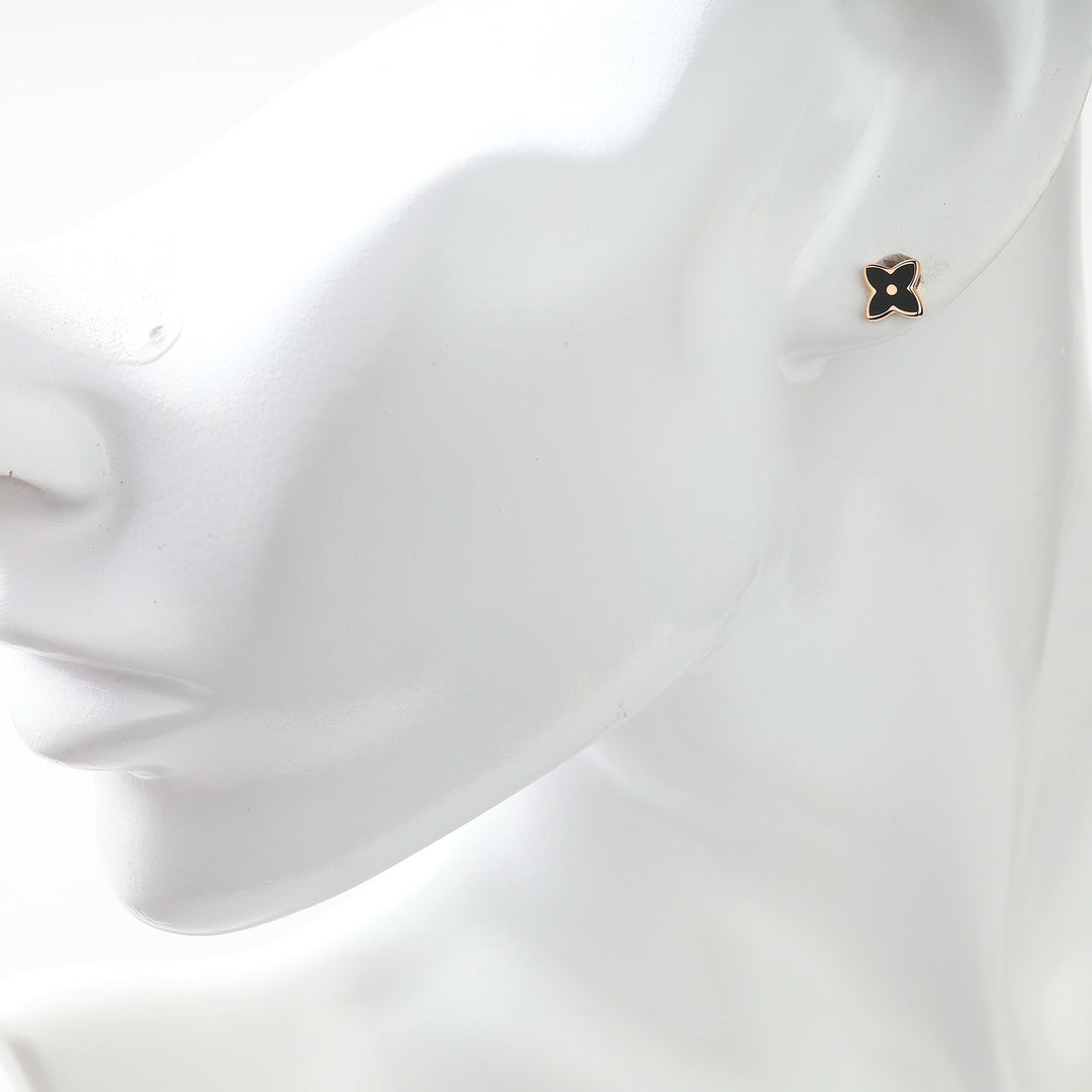 Black enamel rose gold stud earring shown on an ear