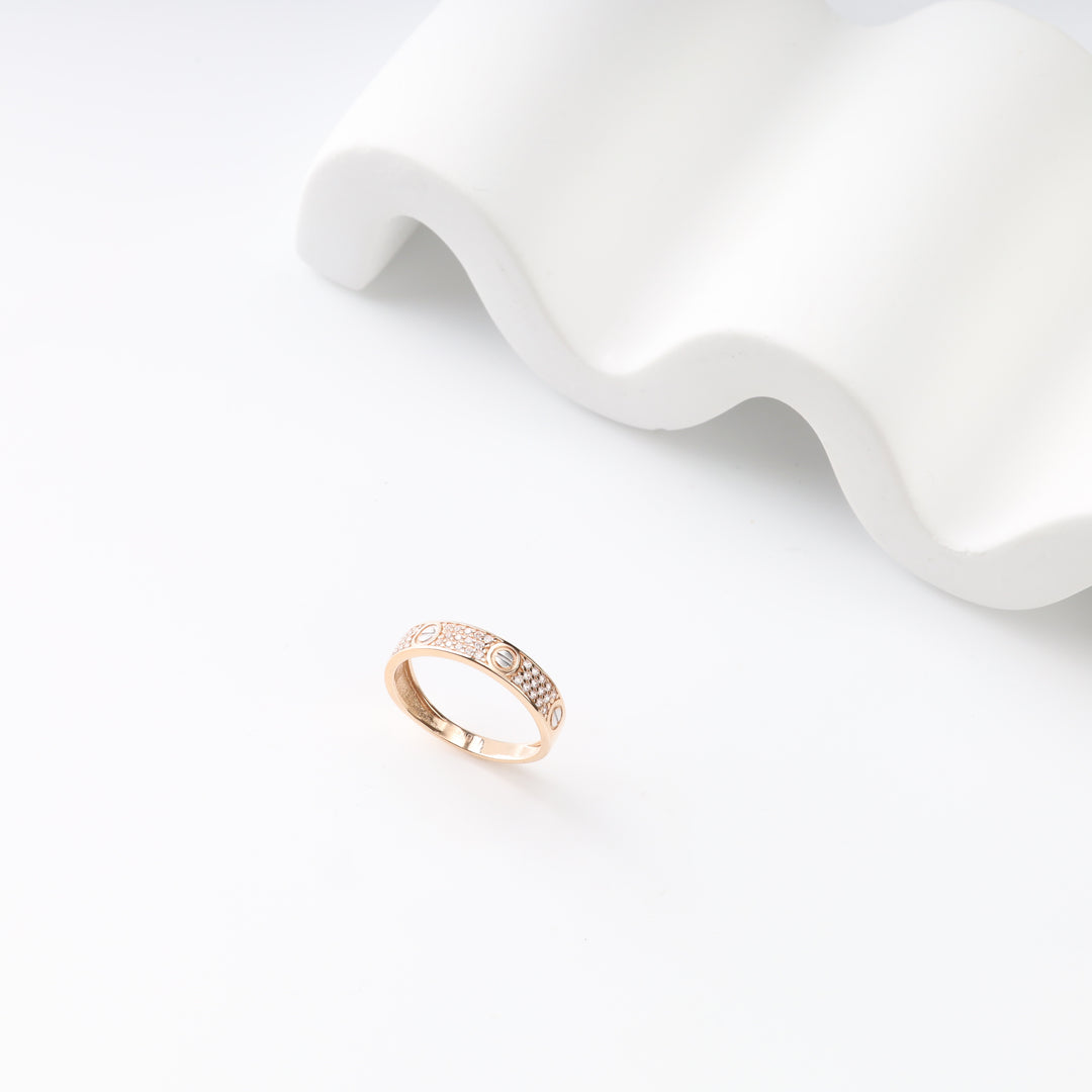 Two-tone stone-set band ring showing repeating circular motifs