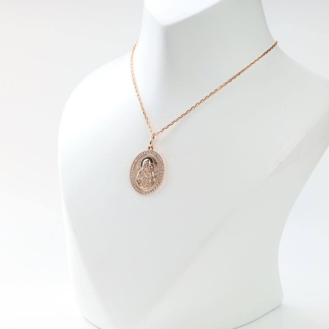 Stone-set Madonna and Child icon pendant displayed on a necklace bust