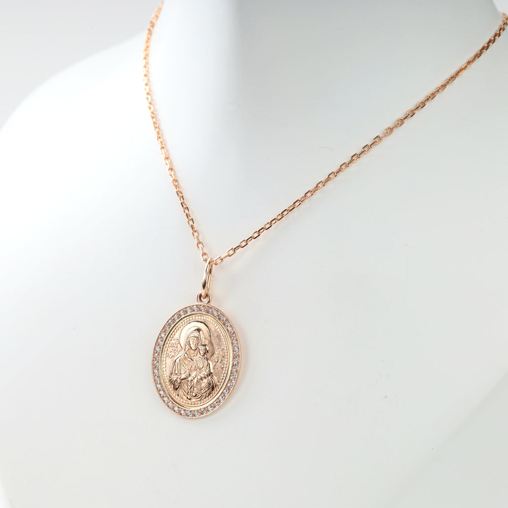 Close view of 14K rose gold icon pendant and clear stones