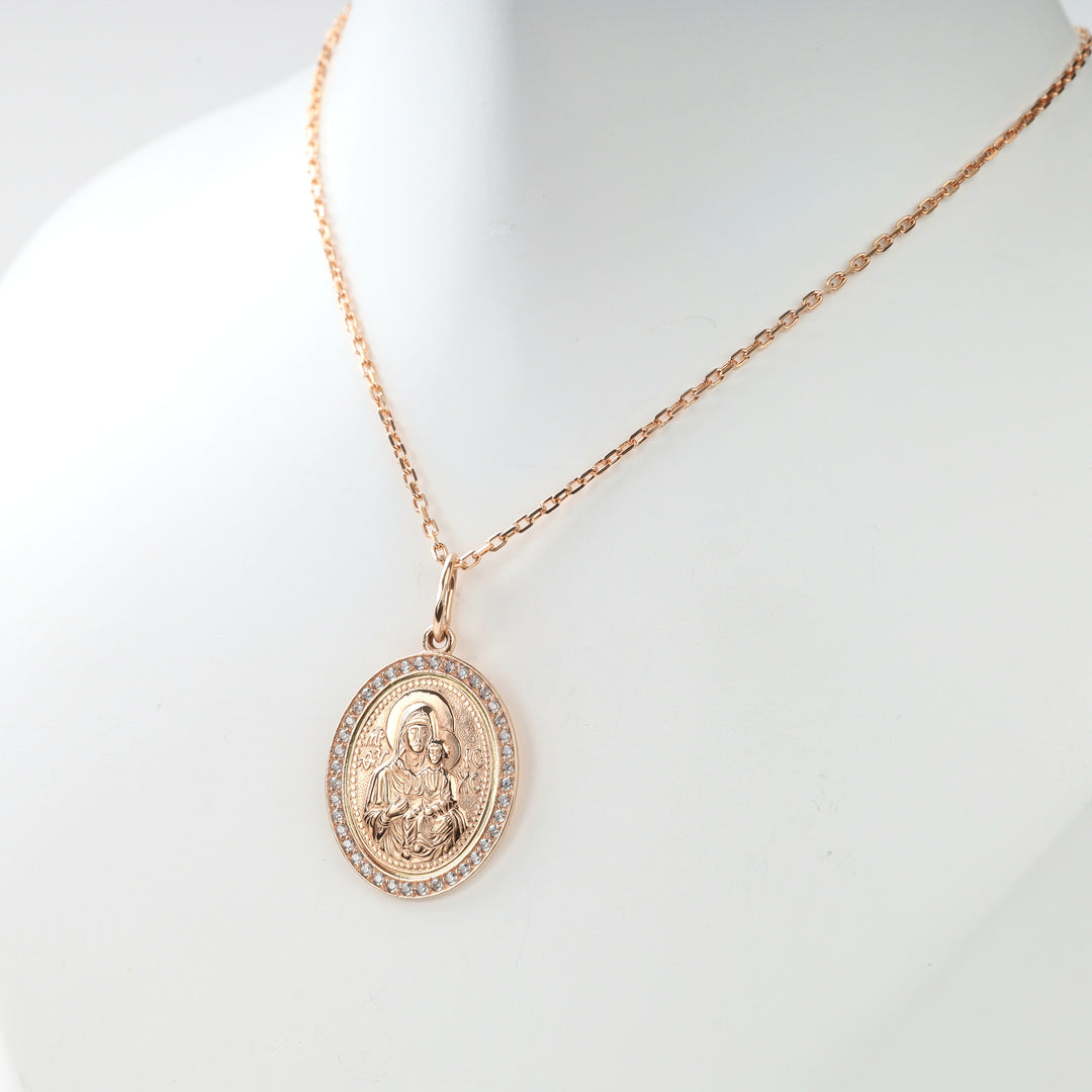 Close view of 14K rose gold icon pendant and clear stones