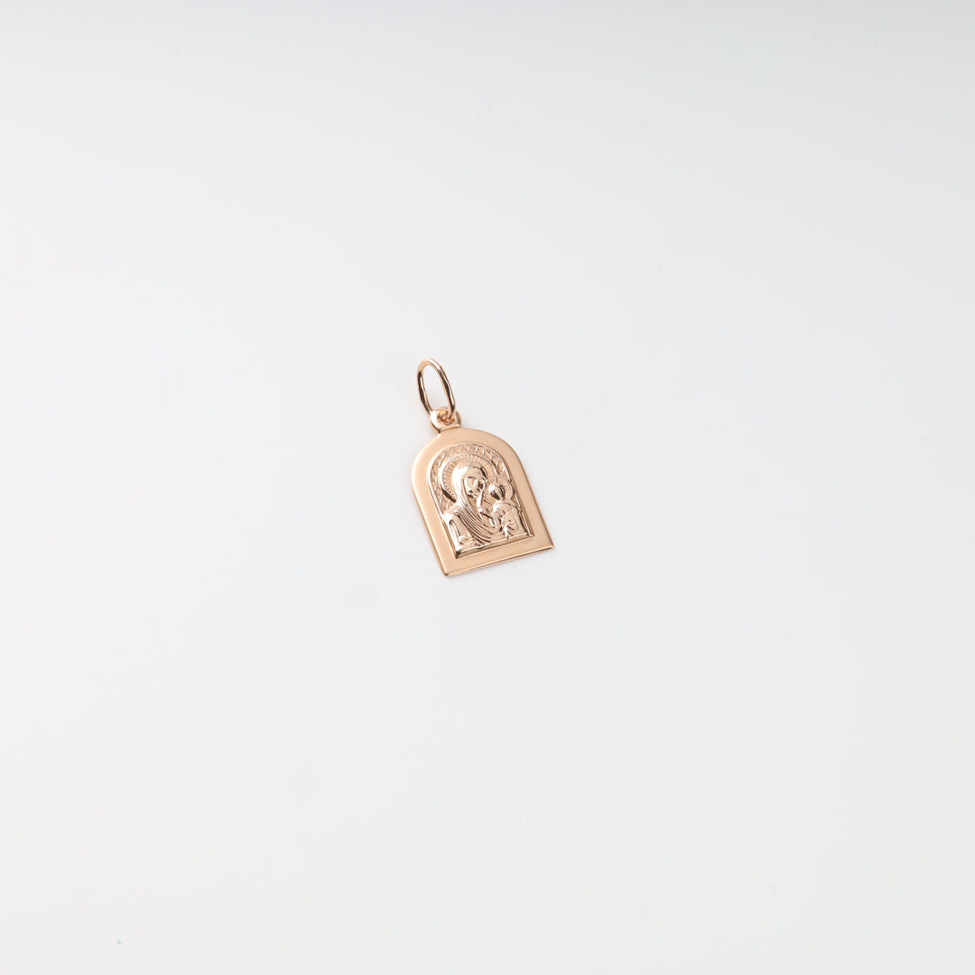Virgin Mary and Child gold pendant showing engraved halo details