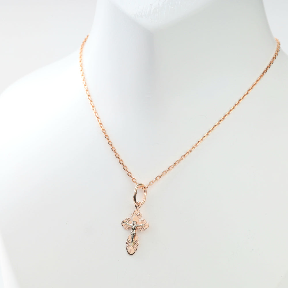 Close view of the fine rose gold chain paired with the religious pendant