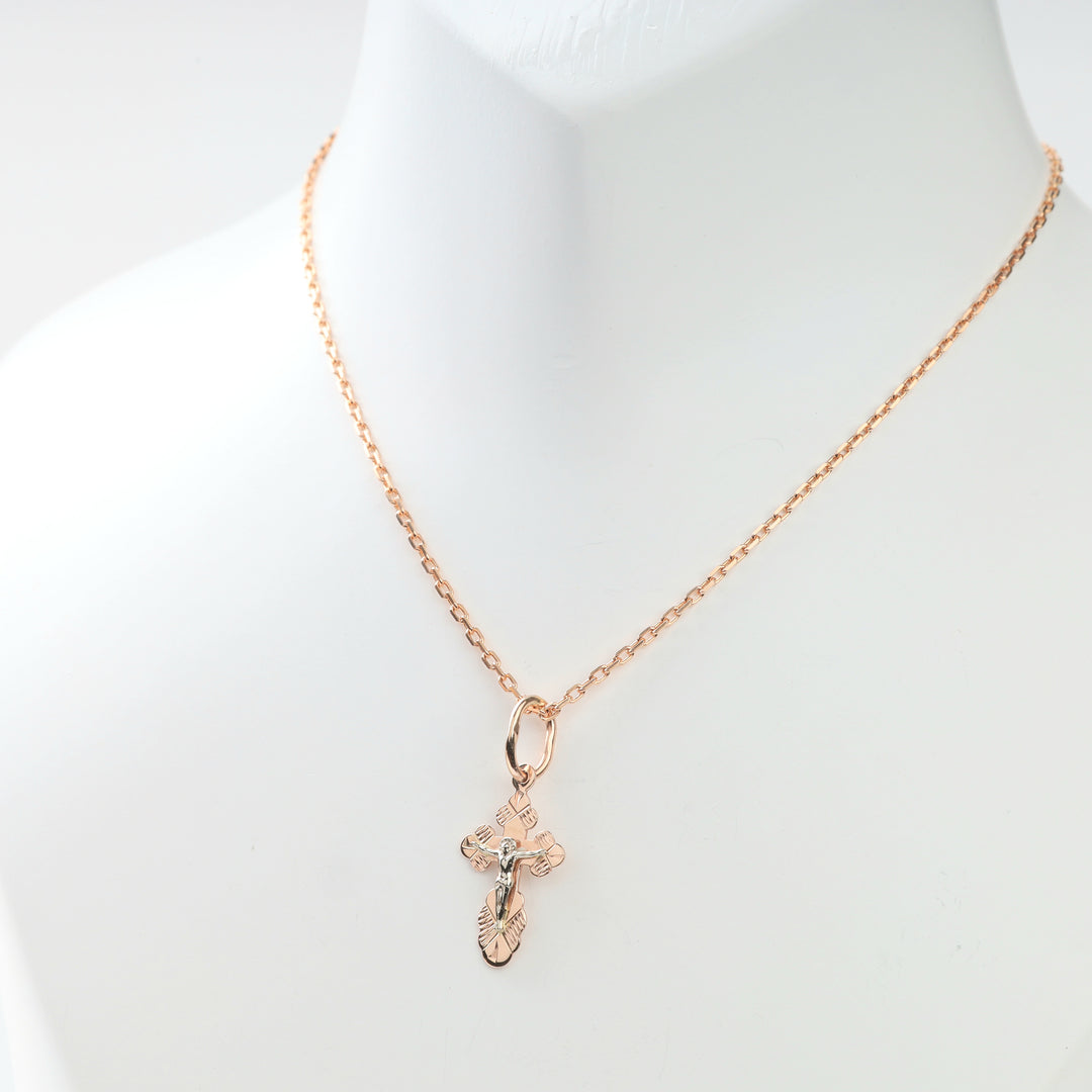 Close view of the fine rose gold chain paired with the religious pendant