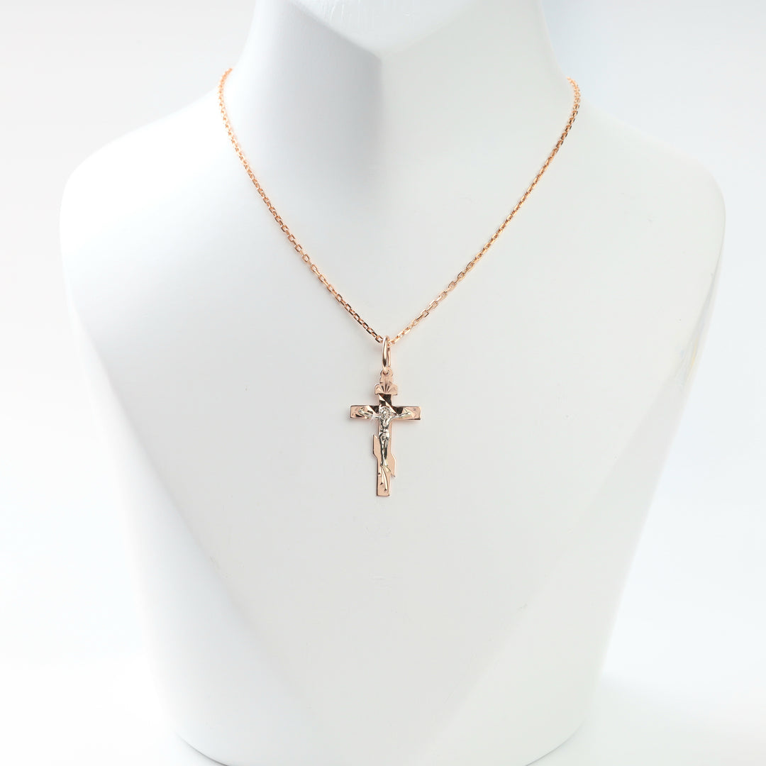 Two-tone gold crucifix cross pendant displayed on a chain