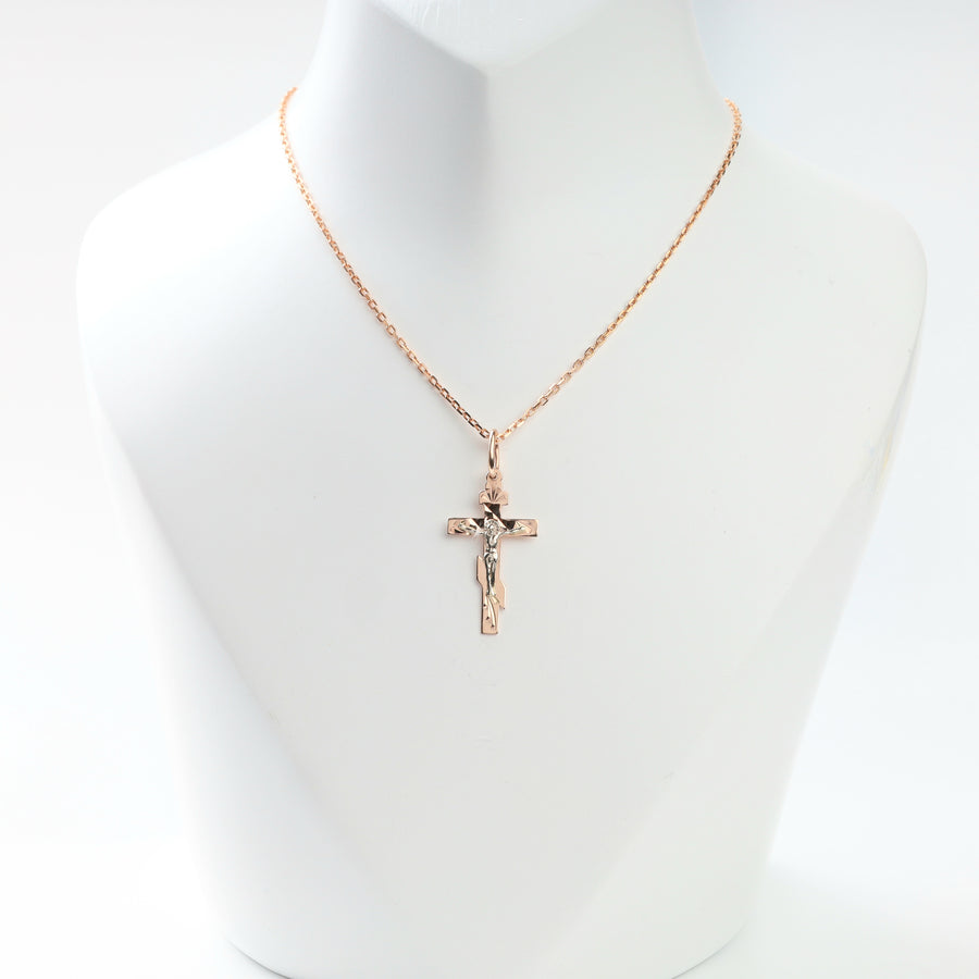 Two-tone gold crucifix cross pendant displayed on a chain