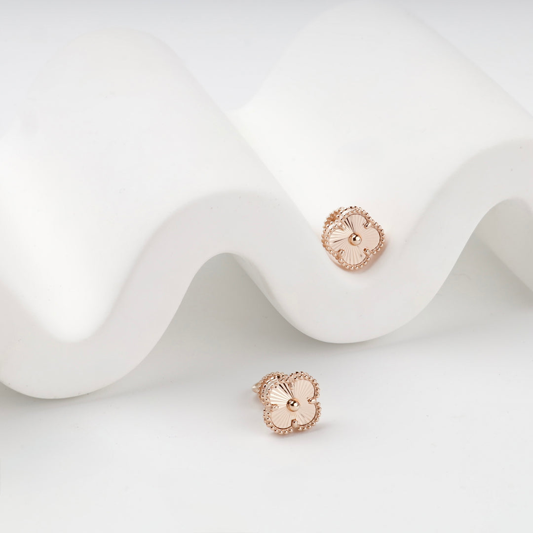 Rose gold clover stud earrings with beaded border, side view