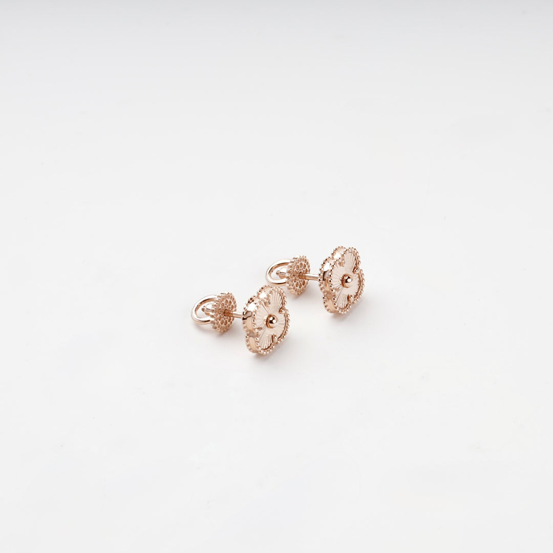 Rose gold clover stud earrings detail close-up