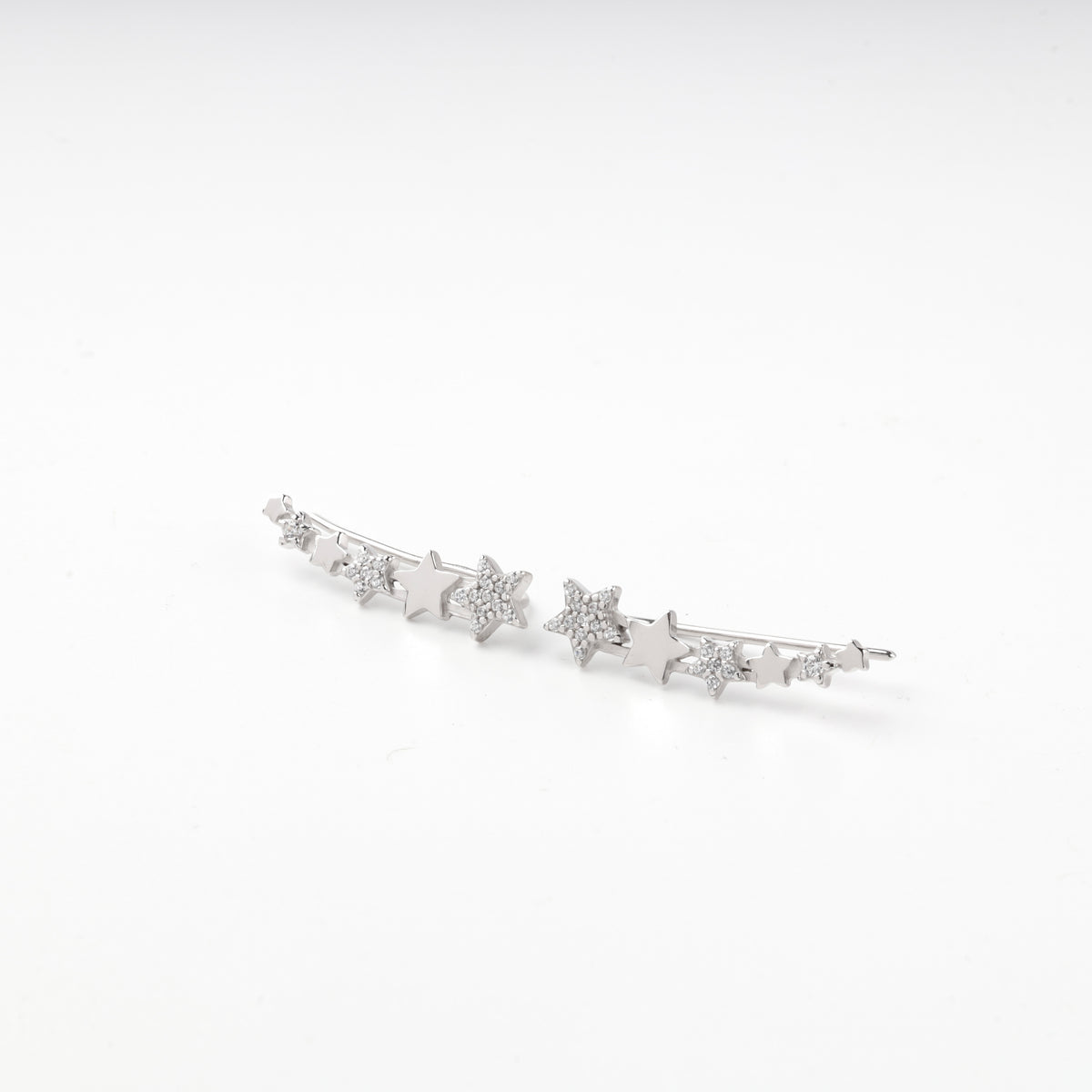 Pair of silver 925 star climber earrings seen from above
