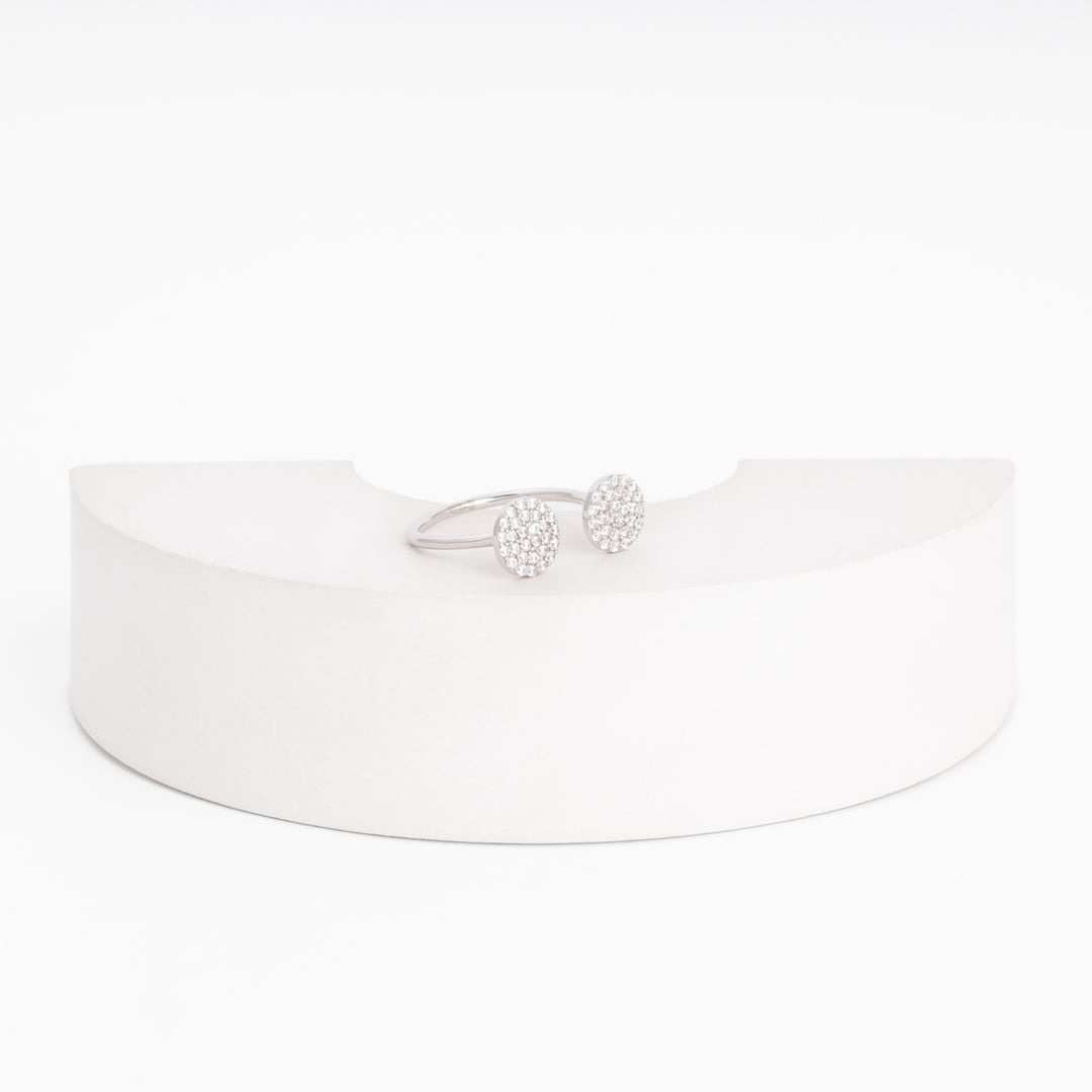 Silver open ring with cubic zirconia pavé discs, close studio view