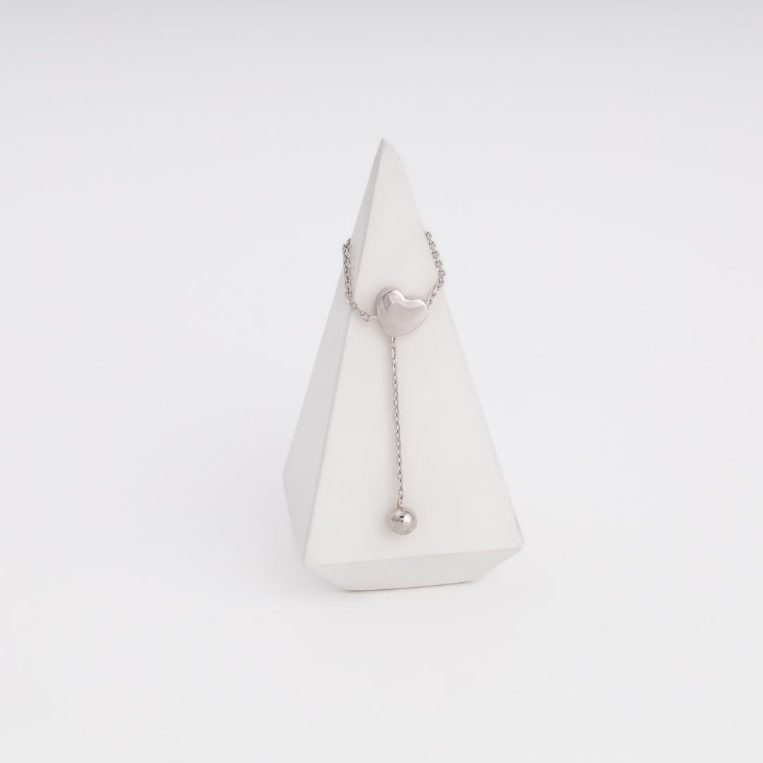 Silver 925 heart ring with dangling ball, side view on stand — Ukrainian Jewelry