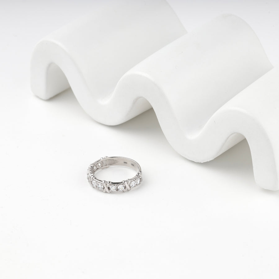 Silver 925 eternity ring resting beside a wavy white prop