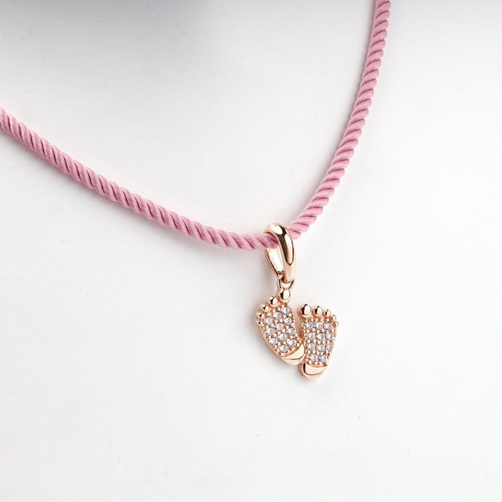 Rose gold baby feet pendant, overhead view