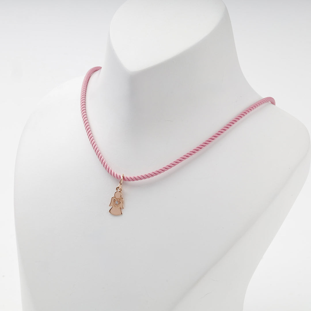 Small rose gold angel pendant on a pink cord, worn view