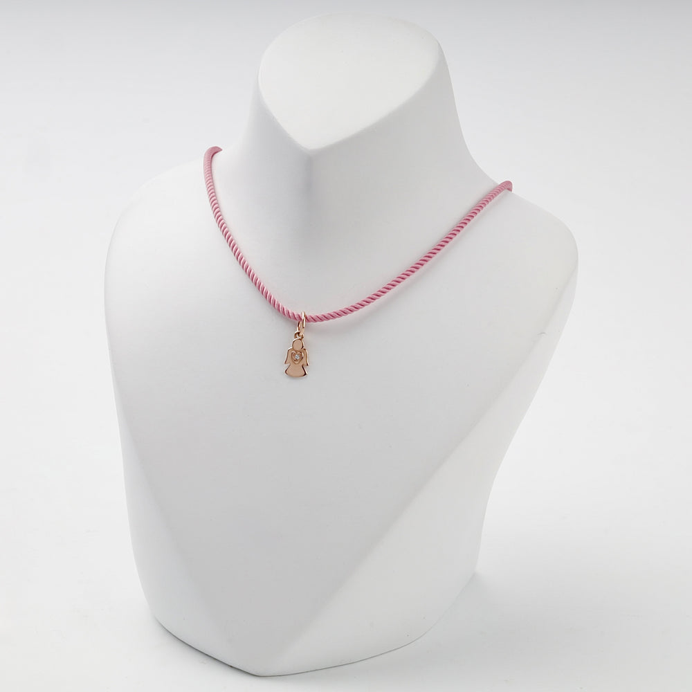 Small solid rose gold angel pendant with heart and cubic zirconia, overhead view