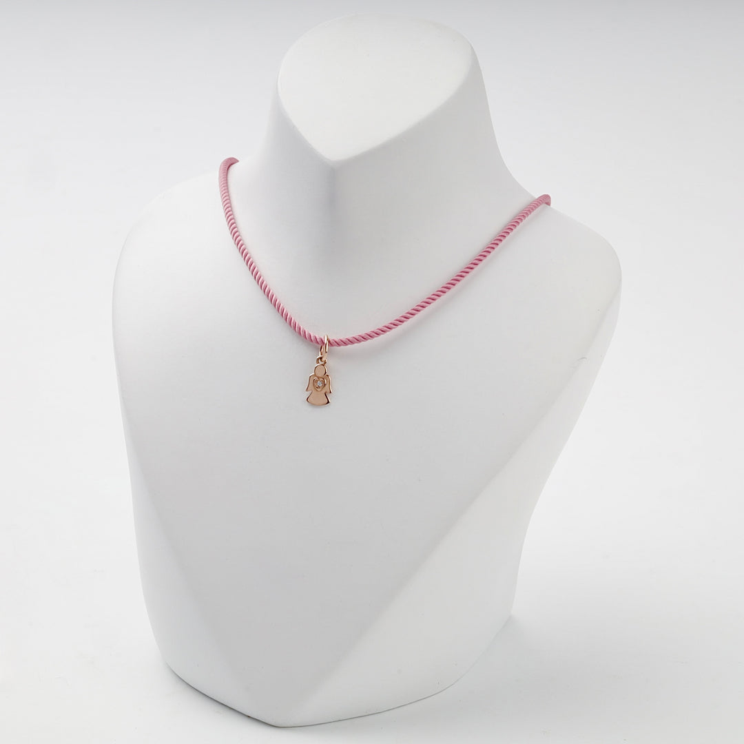 Small solid rose gold angel pendant with heart and cubic zirconia, overhead view